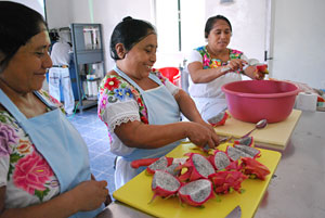 women cutting dragon fruit